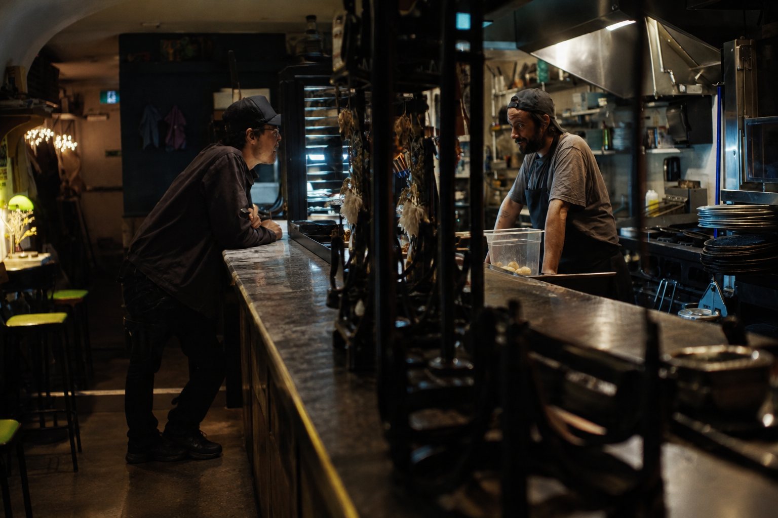 Anna Hopkins on the Dish Pit set with Matthew Gouveia and Austin Hutchings in a warm restaurant interior